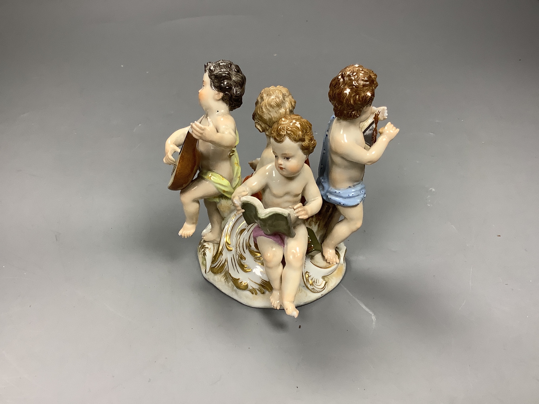 A Meissen group of four putti musicians, late 19th century, 11 cm high, losses